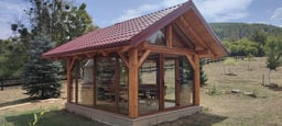 Log cabin house with fireplace and countryside surroundings