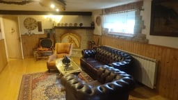 Log cabin house with fireplace and countryside surroundings